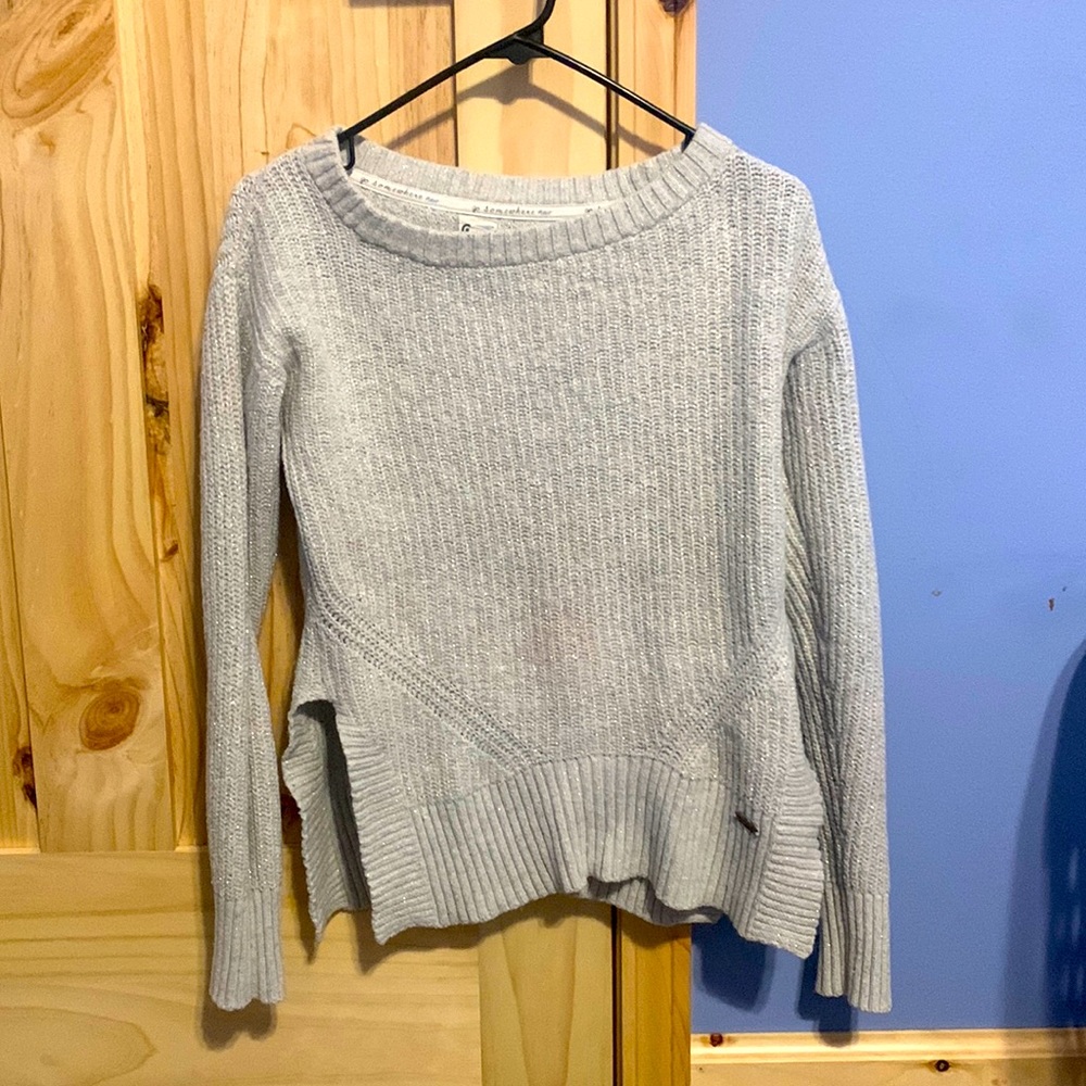 Silver woman’s sweater. It has glitter on it but the glitter. Medium in woman’s.